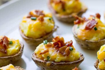 Mini Twice Baked Potato Skins on a white plate. me, you'll gobble these up!