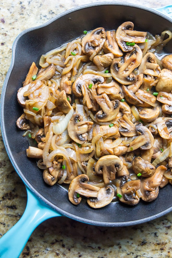 A skillet with cooked Mushroom and Onions