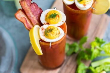 Two bacon and eggs bloody Mary cocktails.
