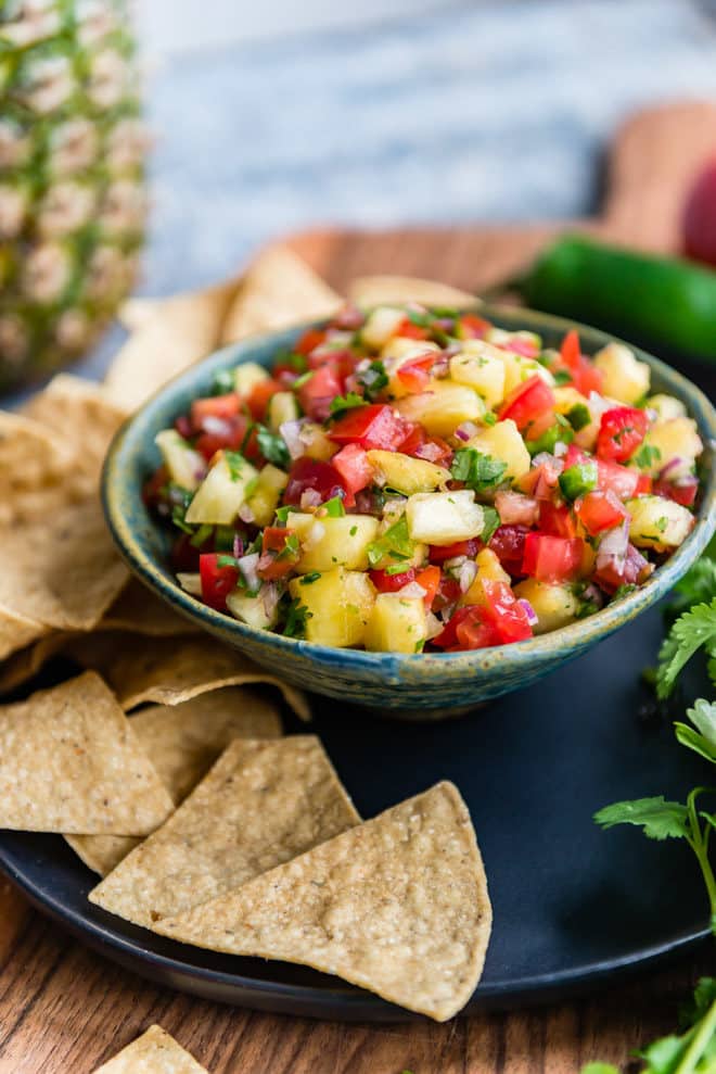 Pineapple salsa in a teal bowl.