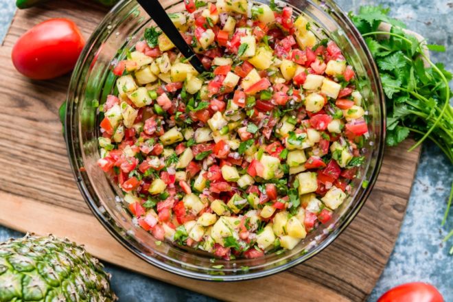 Pineapple salsa in a clear bowl.