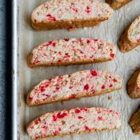 Cherry almond biscotti on a sheet pan lined with parchment paper.