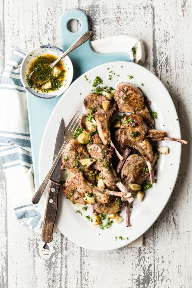 This fantastic lamb chops recipe uses whole garlic cloves which caramelize in the skillet alongside the chops. Once the lamb is cooked, the cloves become a part of a quick pan sauce with lemon juice, herbs, and a pinch of red pepper. A sophisticated dinner in minutes, not hours, for lamb enthusiasts everywhere.