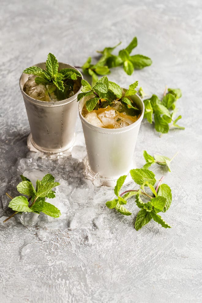 Two mint julep in silver cups.