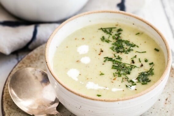 Potato leek soup in a white bowl.
