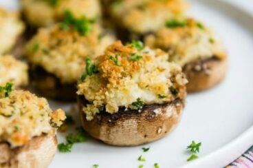 Vegetarian stuffed mushrooms on a white plate.
