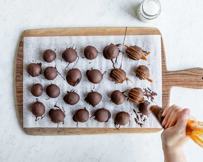 The ultimate Oreo Cookie Balls recipe is right here, waiting to be rolled into your family’s holiday cookie line-up. These no-bake beauties get drizzled with a homemade Salted Caramel Sauce, but you can change them up in a million different delicious, chocolatey ways.