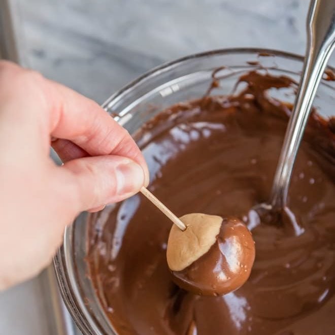 An easy Peanut Butter Buckeyes recipe. While popular in Ohio, The Buckeye State, anyone can get excited about peanut butter balls dipped in melted chocolate! 
