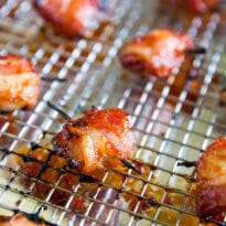 Bacon Wrapped Water Chestnuts on a cooling rack placed on a baking sheet. salty, sweet, and insanely addictive. Top with 2-ingredient barbecue sauce and broil to perfection in minutes!