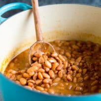 A side shot of chipotle pinto beans in a pot.