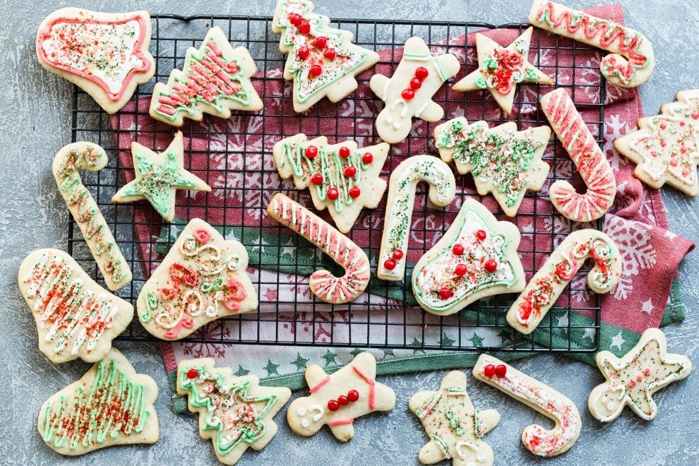 Frosted Christmas sugar cookies on a cooling rack.