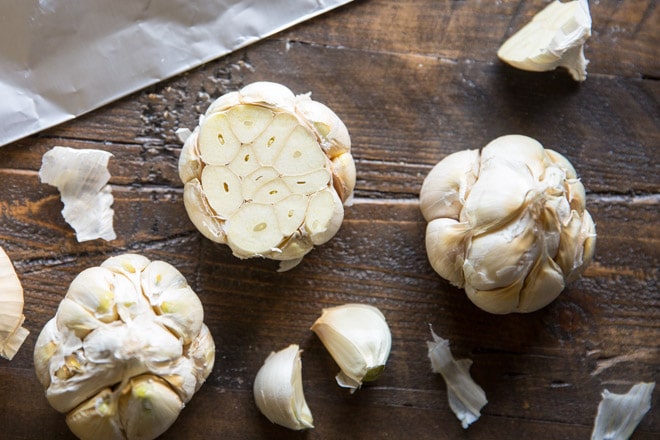 An easy recipe for how to roast garlic in the oven. Mash roasted garlic cloves and add to potatoes, soups, and salad dressings or spread directly on bread.