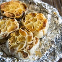 An easy recipe for how to roast garlic in the oven. Mash roasted garlic cloves and add to potatoes, soups, and salad dressings or spread directly on bread.