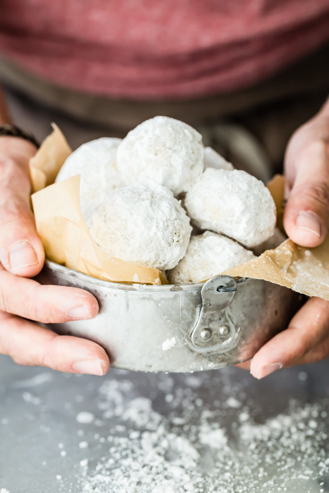 These easy Mexican Wedding Cookies have walnuts in the dough and are rolled in powdered sugar so they look exactly like snowballs! Perfect for Christmas.