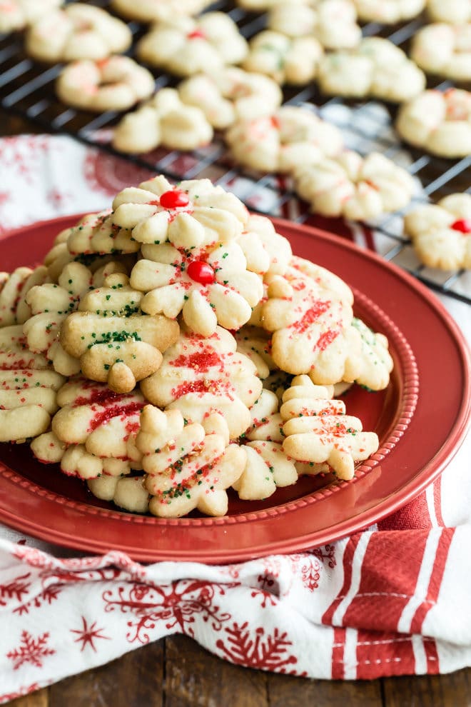 Spritz cookies on a red plate.
