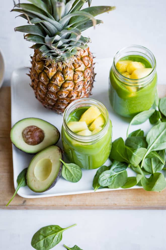 Pineapple paradise spinach smoothie in a clear mason jar.