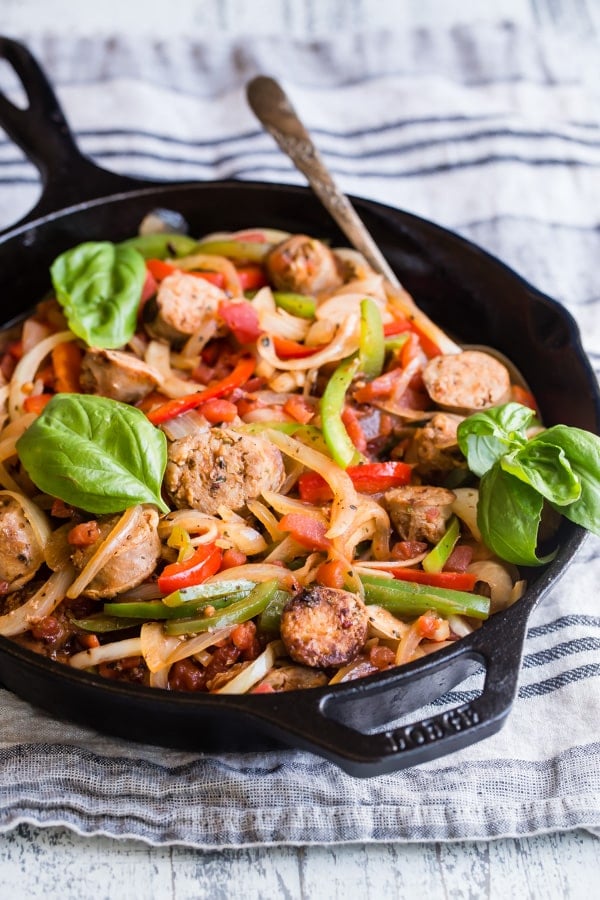 Italian sausage and peppers in a cast iron skillet.