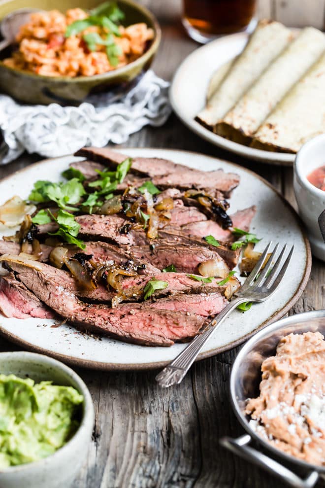 Carne asada on a white plate with a fork.