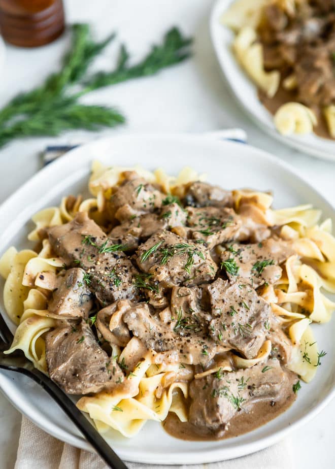 This delicious, easy Beef Stroganoff is a dinner that just feels right when all you want is a big bowl of noodles or mashed potatoes topped with chunks of tender beef in a creamy mushroom sauce. Go ahead and have another bowl—you can eat salad tomorrow.