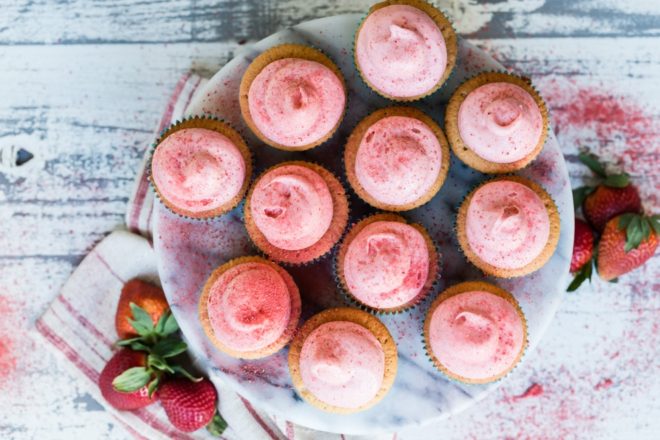 Strawberry cupcakes on a gray platter.