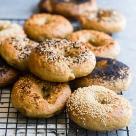 Homemade bagels on a cooling rack.