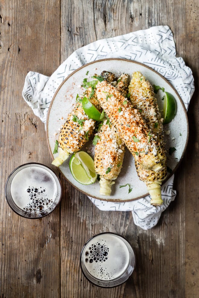 Elotes on a gray plate.