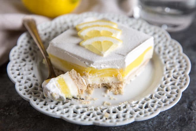 Lemon Lush is an easy dessert recipe made with layers of pecan shortbread, sweetened cream cheese, lemon pudding, and whipped topping. Rediscover this classic summer dessert or enjoy it for the first time. You'll want to go light on dinner so you have plenty of room left for Lemon Lush!