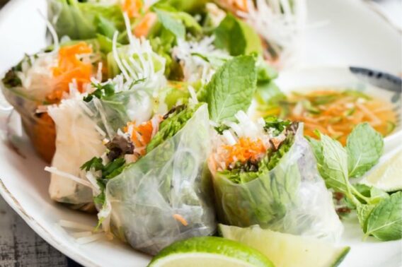 Vietnamese spring rolls on a white platter.