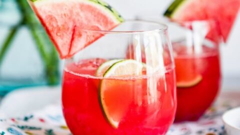 Watermelon agua fresca in glasses with wedges of watermelon.