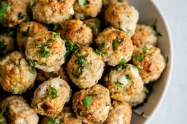 Turkey meatballs in a white serving bowl.
