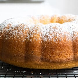 A hot milk cake on a cooling rack.