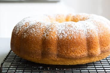 A hot milk cake on a cooling rack.