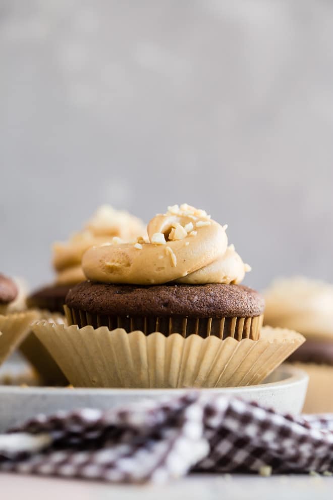 Peanut butter and chocolate are the lifelong besties of food, and these homemade Chocolate Cupcakes with Peanut Butter Frosting will prove it. Deep, dark buttermilk chocolate cake slathered with a soft and creamy peanut butter frosting…what a beautiful friendship. Bring a batch to your next party, but only if you want to delight absolutely everyone in the room.