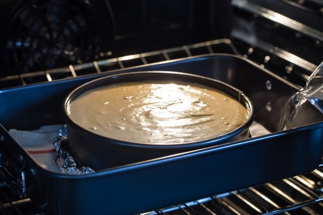 A cheesecake baking in the oven.