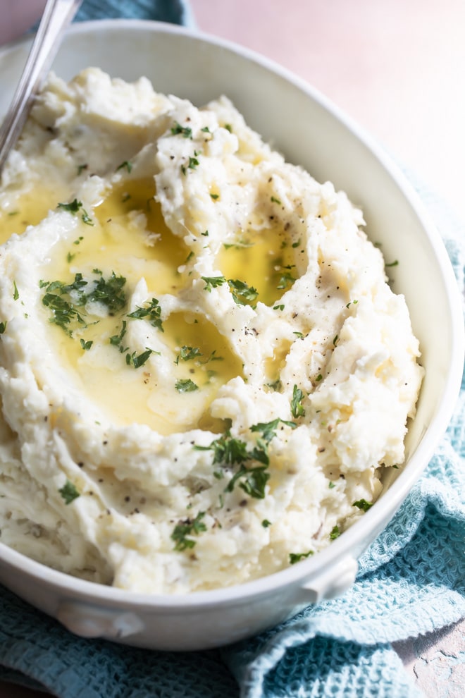 Make ahead mashed potatoes in white serving dish.