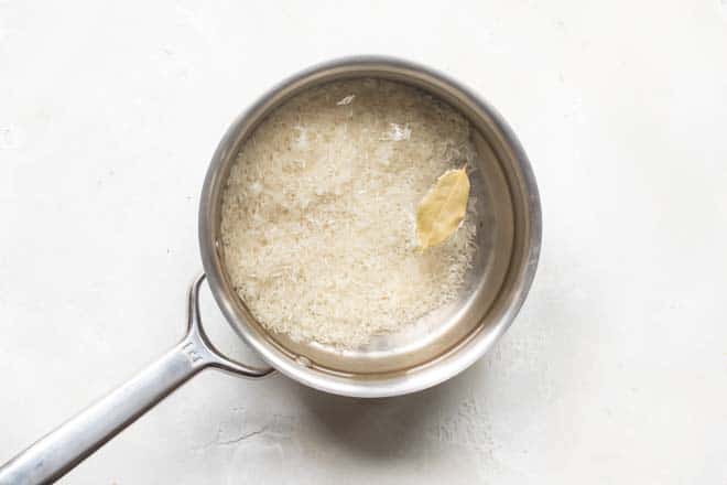 White rice cooking in a silver pot.