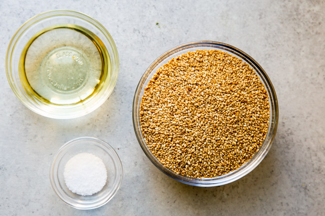 Tahini ingredients in various bowls on a gray counter top.