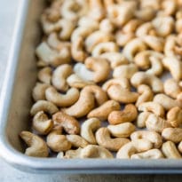 Roasting cashews brings out their soft, sweet flavor and adds a little extra crunch in the process. It’s easy to learn how to roast cashews and it will up your cooking game with very little effort.