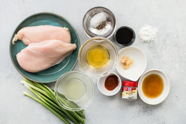 Honey garlic chicken ingredients in various bowls on a gray counter.