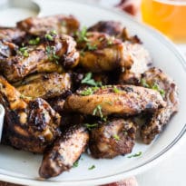 Smoked chicken wings on a white platter.