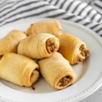 Two ingredient Italian sausage rolls on a white plate.