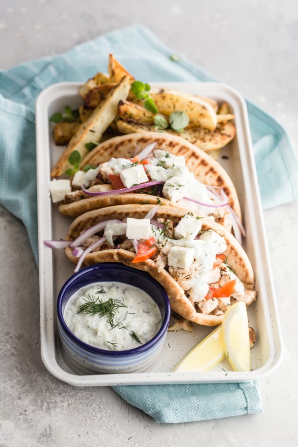 Whatever you're throwing on the grill this weekend, there's room for Chicken Gyros. The tender, yogurt marinated  chicken tastes incredible tucked into pita with fresh veggies and slathered with an easy, homemade tzatziki sauce.