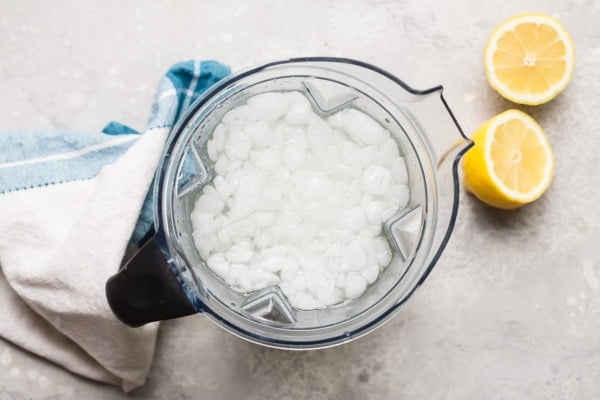 An overhead shot of how to make lemonade in a blender.