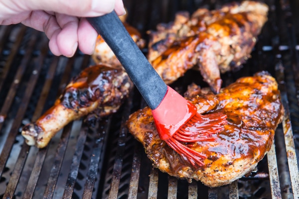 Smoky and sticky-sweet, there's nothing like tucking into a plate piled high with juicy grilled Barbecue Chicken. Here's a recipe for barbecue chicken with hardwood chips for extra flavor, including a last minute mopping with your favorite BBQ sauce. 