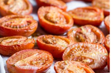Roasted tomato halves in a baking pan.