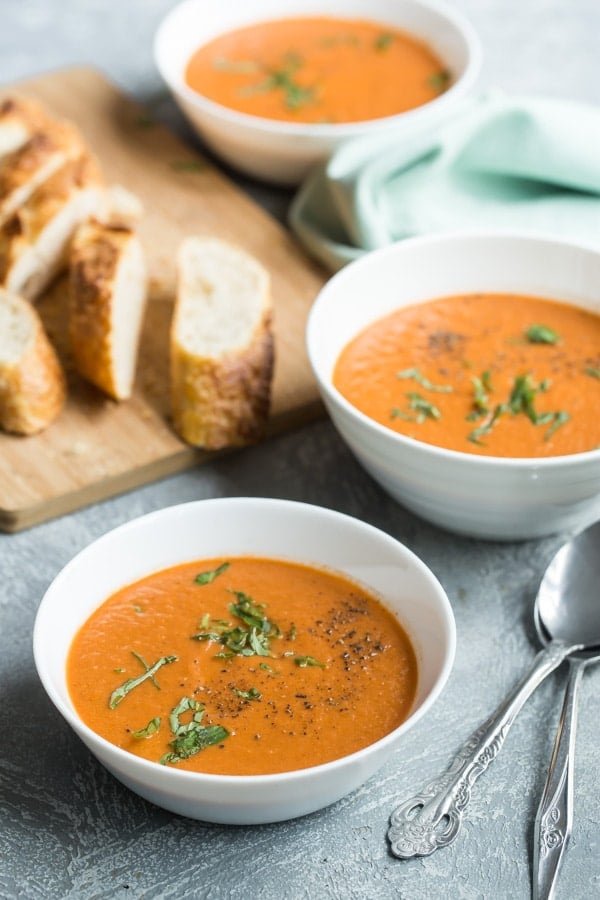 Roasted tomato soup in white bowls.