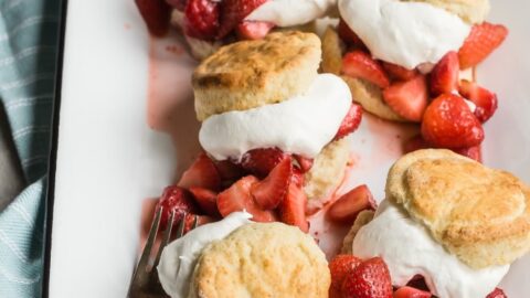 Strawberry shortcakes on a white platter.
