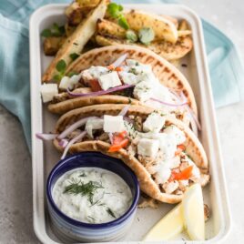 Chicken gyros in a white serving tray.