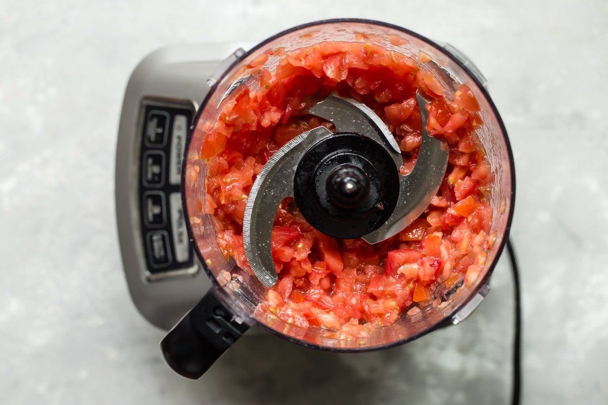 Vegetables being chopped in a food processor.