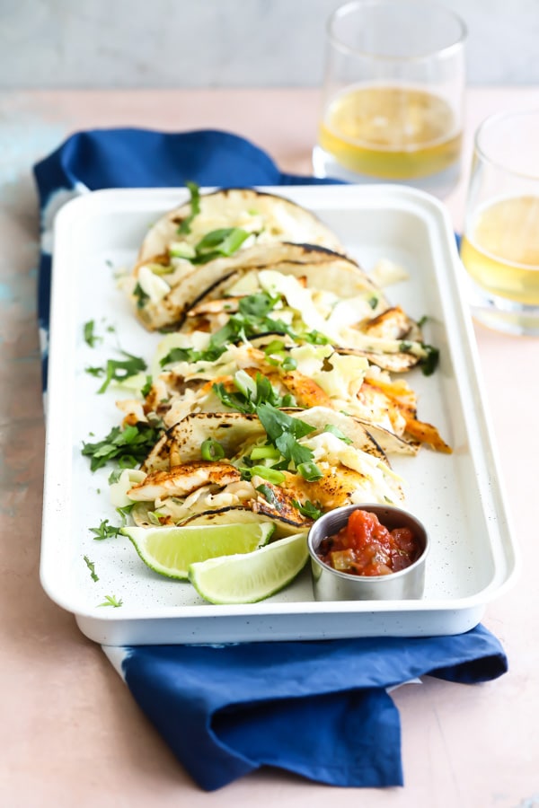 Summer means lots of easy Grilled Fish Tacos with Cabbage Slaw, tucked into smoky, grilled corn tortillas and topped off with a squirt of lime. When you’re not eating them, you’ll be dreaming about them.